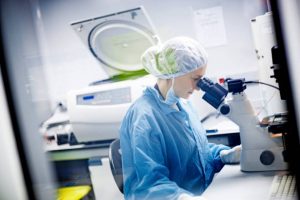 Woman working in a laboratory using microscope Woman working in a laboratory using microscope